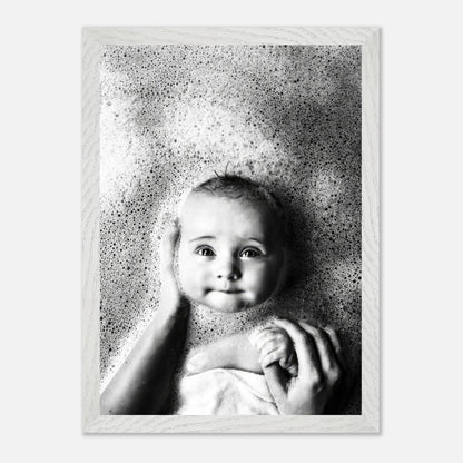 Vintage framed print of a smiling baby in a bubble bath, capturing the innocence of childhood.