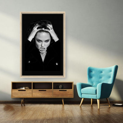 Angelina Jolie Smoking Framed Canvas Print hanging in modern living room with teal chair and wooden furniture.