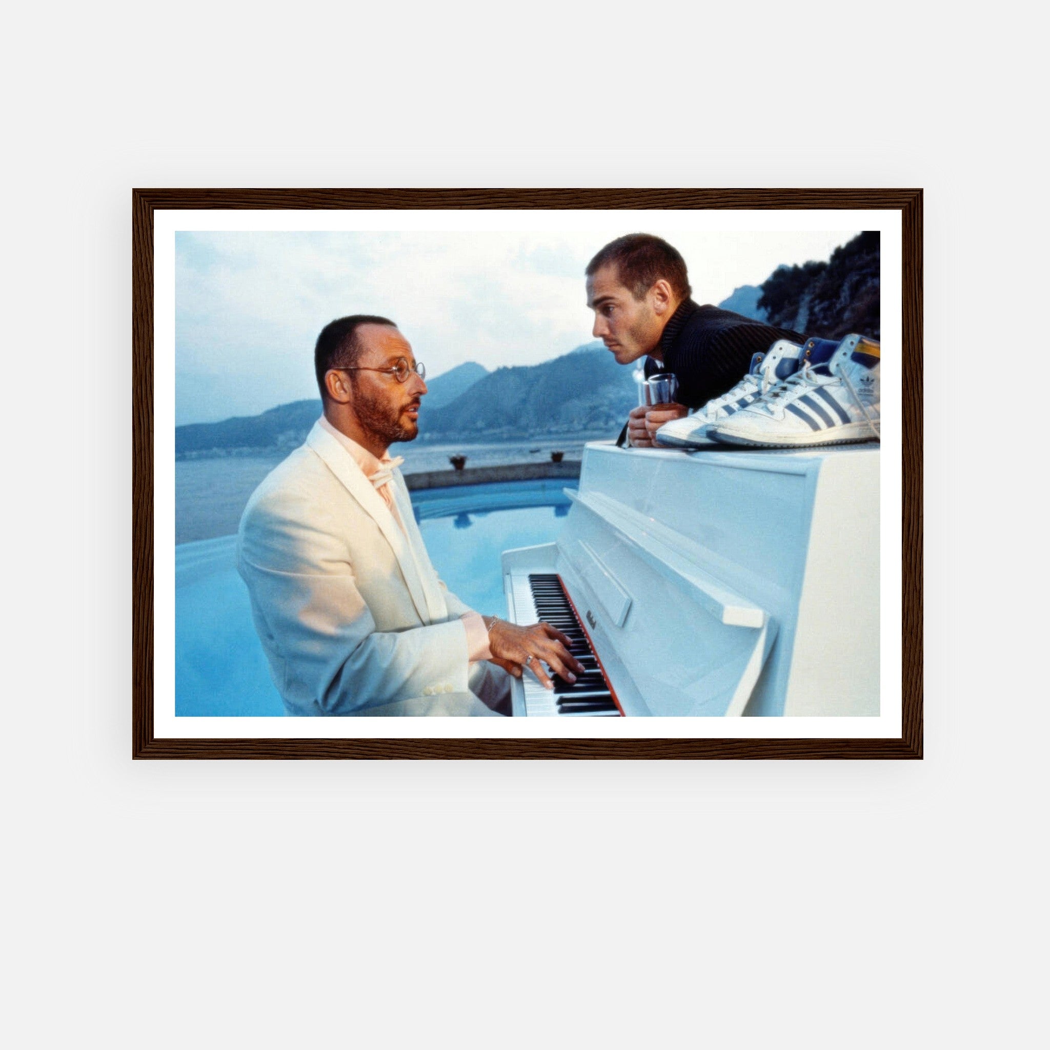 Jean Reno Piano Framed Print capturing an iconic moment from "The Big Blue" against a serene ocean backdrop.