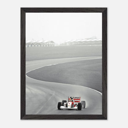 Vintage framed art of 1988 McLaren MP4/4 racing, featuring Ayrton Senna on a track, capturing Formula 1's iconic legacy.