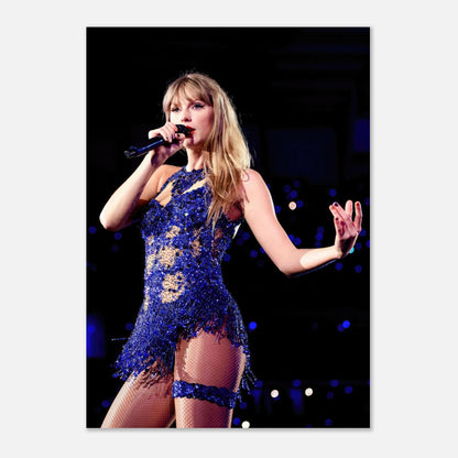 Taylor Swift performing in a dazzling blue outfit during a concert, capturing the energy of live music in a stunning photo poster.