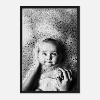 Framed black-and-white canvas print of a baby enjoying bath time surrounded by gentle bubbles.