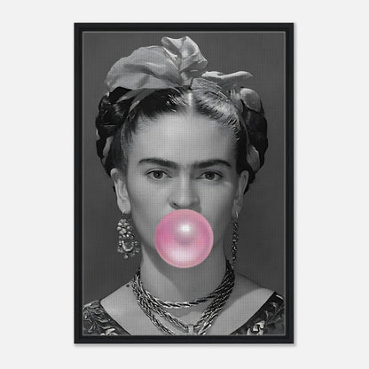 Frida Kahlo Bubble Gum Framed Canvas Print featuring grayscale portrait with pink bubble gum, framed in natural wood.