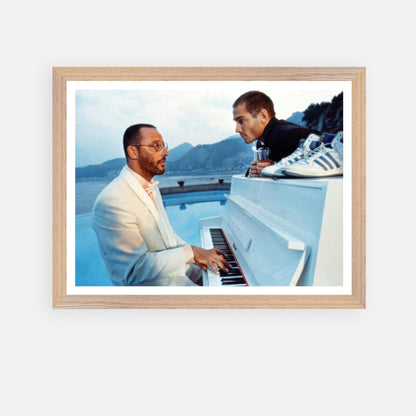 Jean Reno playing piano with scenic backdrop in vintage framed print from "The Big Blue" film.