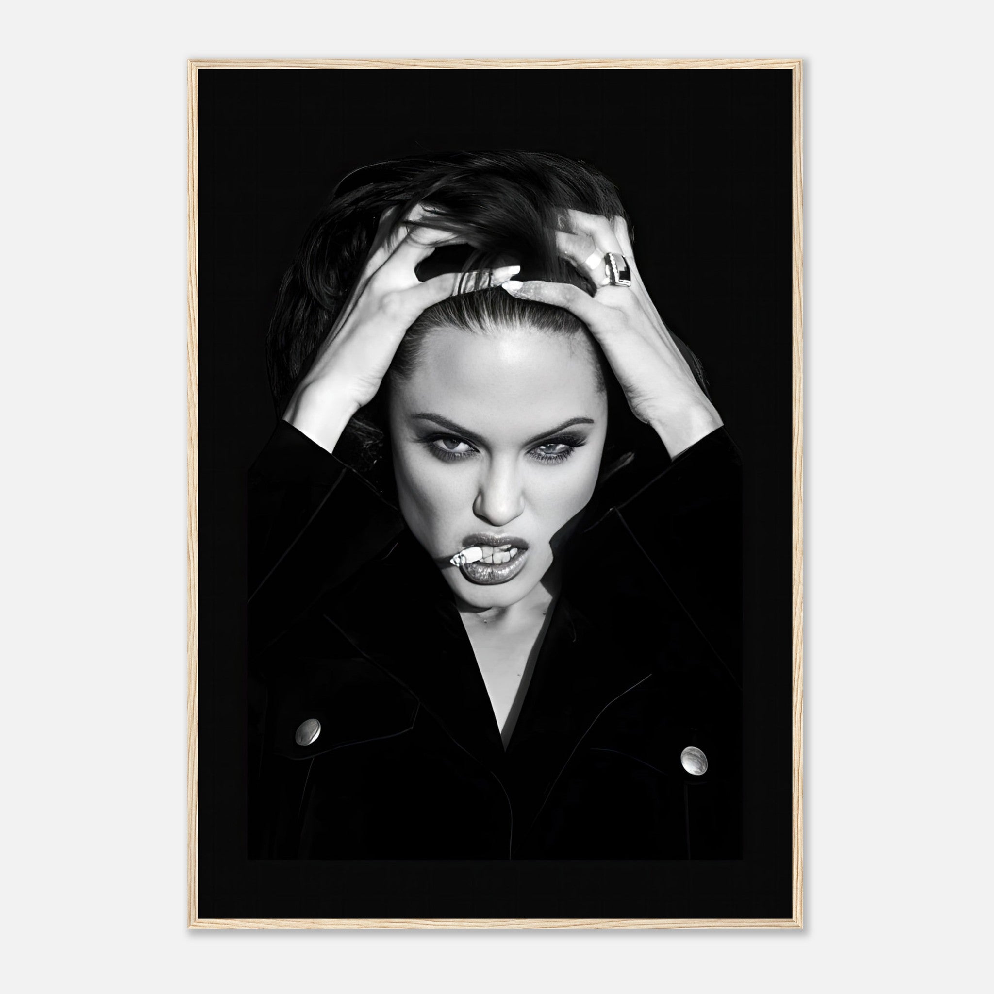 Framed black-and-white print of a fierce Angelina Jolie, showcasing dramatic contrast and bold glamour.