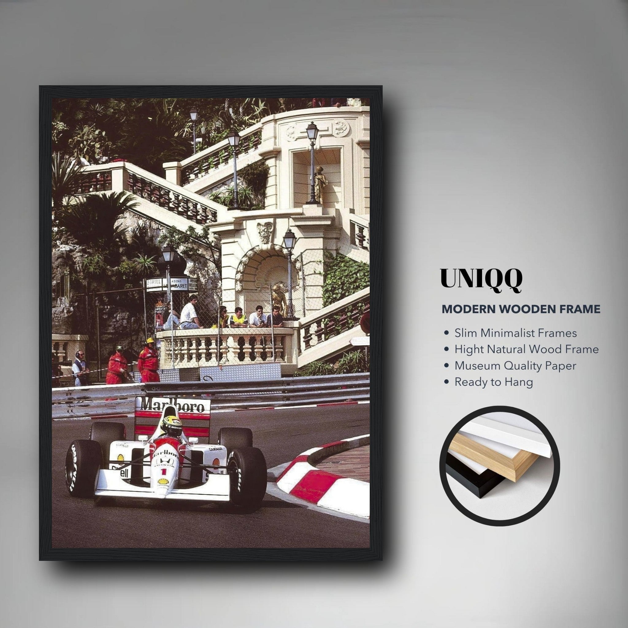 Framed print of Ayrton Senna racing at the Monaco Grand Prix, featuring a sleek wooden frame and vibrant colors.