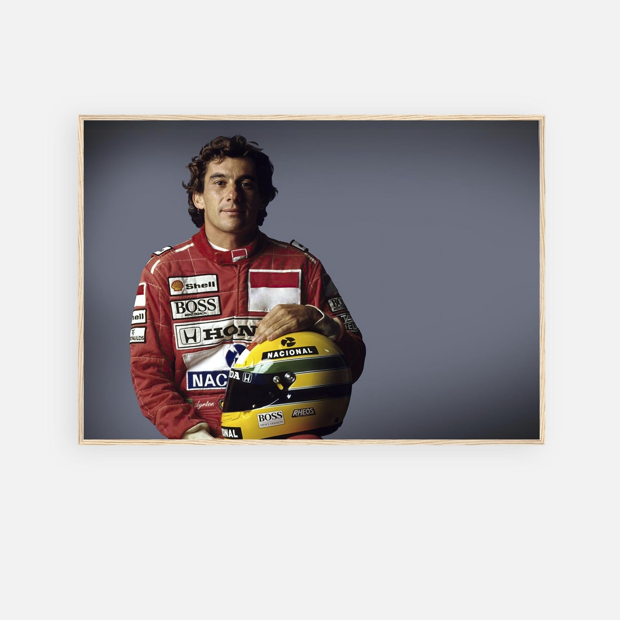 Ayrton Senna in red racing suit holding a helmet, framed print celebrating F1 motorsport legend for decor.