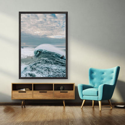 Big wave surfing fine art print displayed in a modern living room with teal chair and wooden furniture.