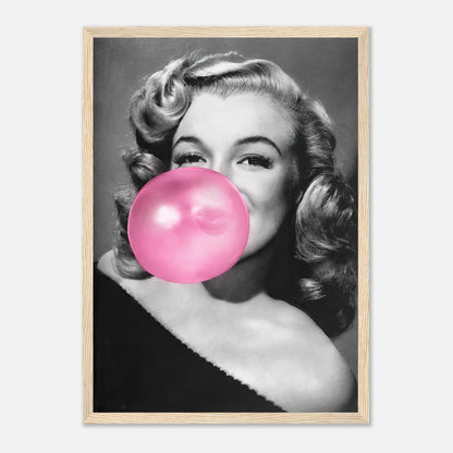 Marilyn Monroe blowing a pink bubble gum in a stylish black and white framed print, adding glamour and quirk to décor.