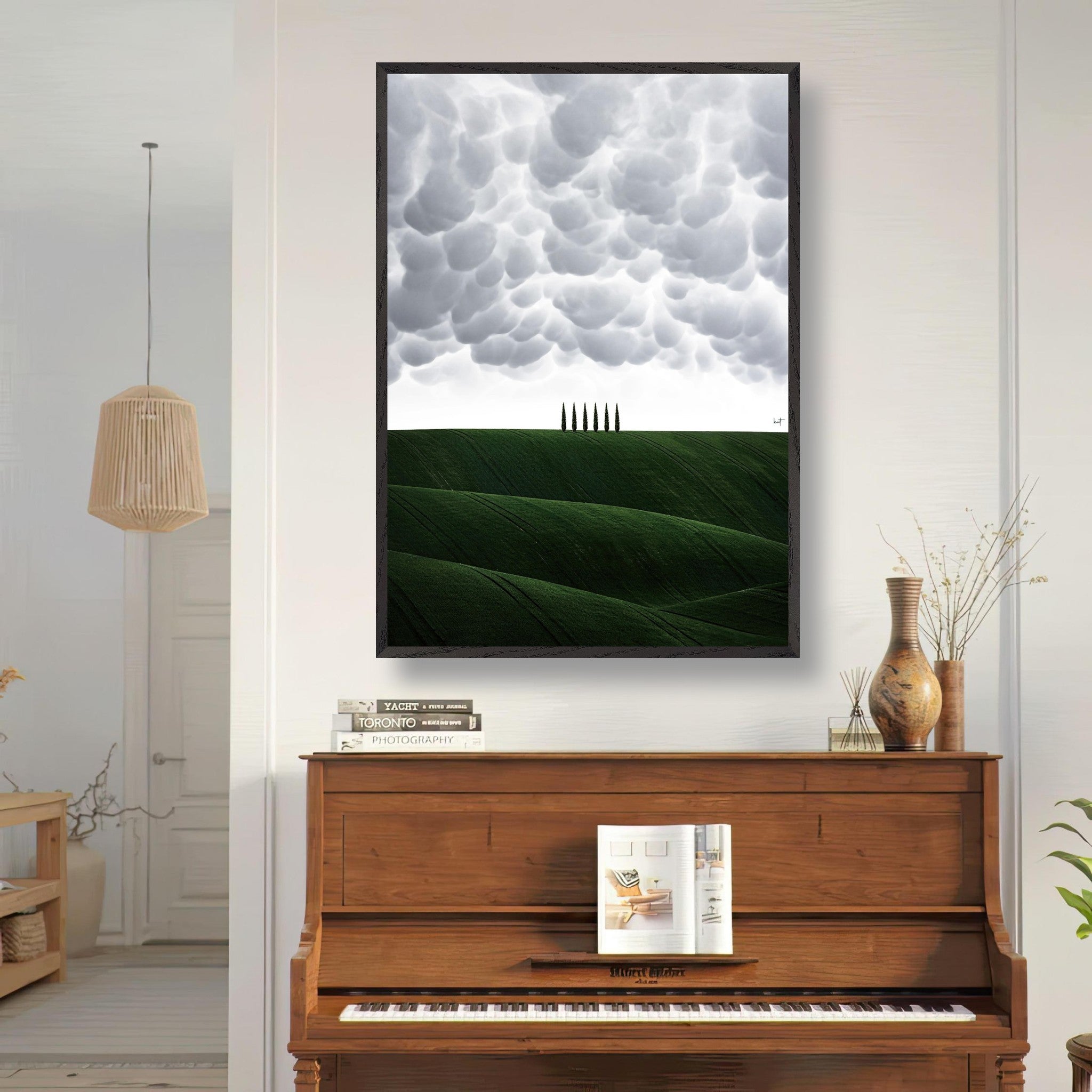 Toscana vintage framed art featuring lush green hills and dramatic clouds, displayed above a piano in a cozy living room setting.