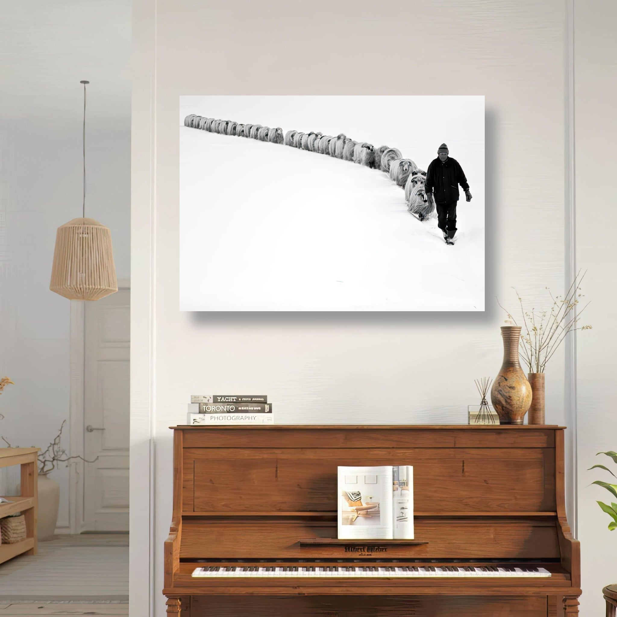 Black-and-white poster of a shepherd leading a flock in a snowy landscape, showcasing harmony with nature.