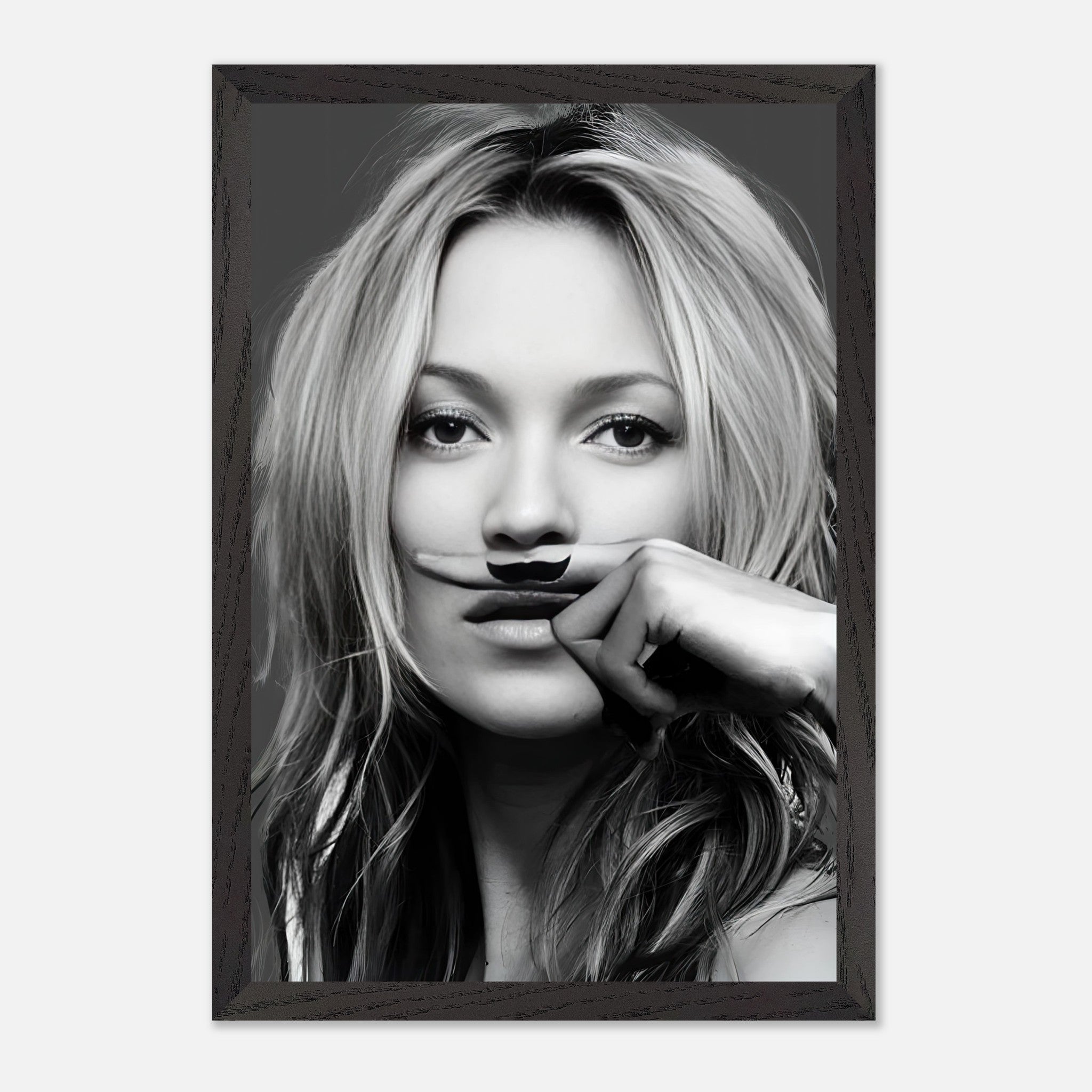 Vintage framed print of Kate Moss with a playful mustache in black-and-white styling. Perfect for stylish wall decor.