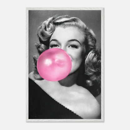 Vintage framed print of Marilyn Monroe blowing a pink bubble gum, showcasing her iconic style and charm.