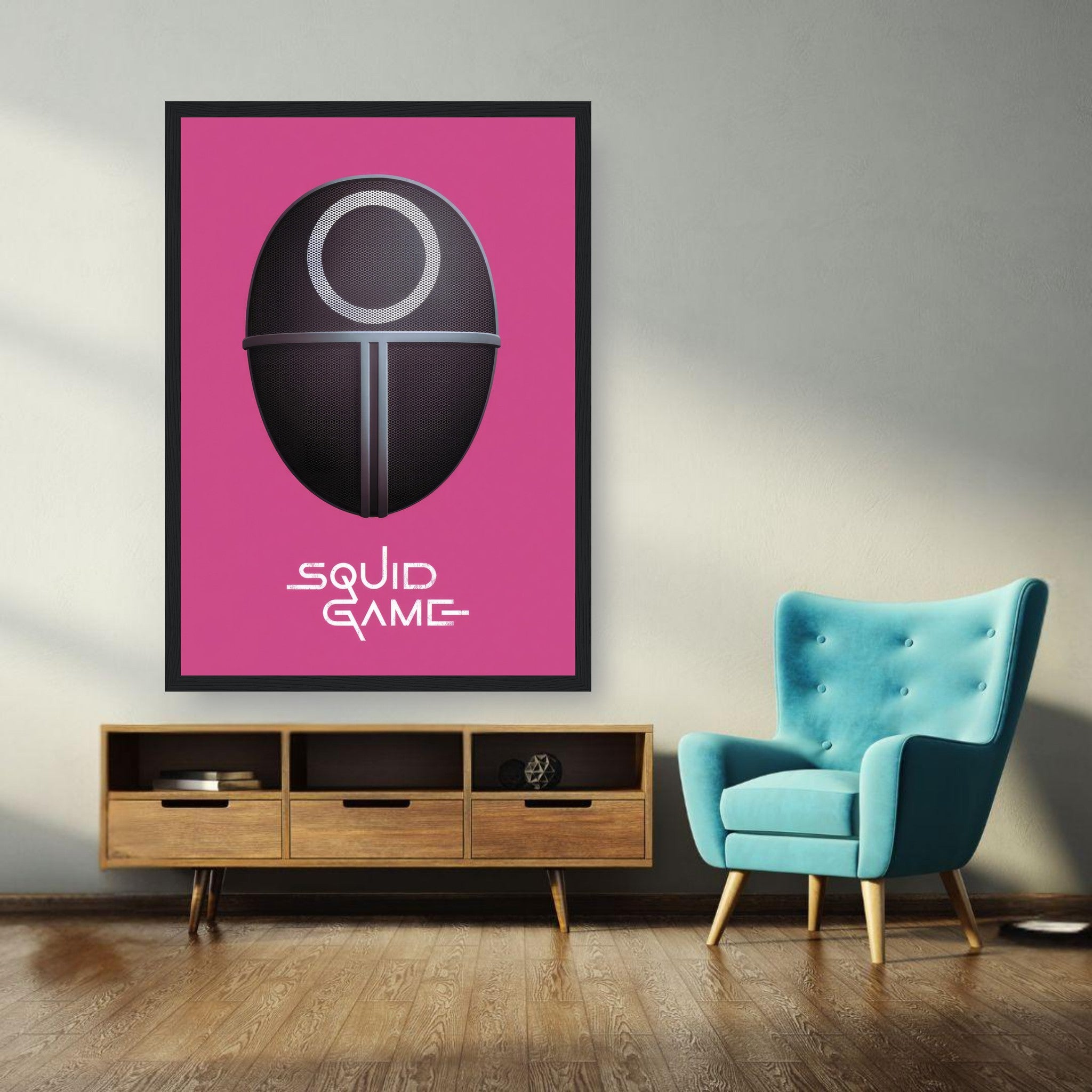 Squid Game Guard Mask framed print on pink background displayed in a modern living room with teal chair.