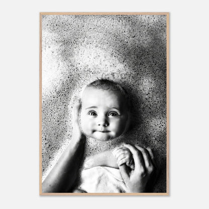 Black-and-white fine art print of a baby enjoying bath time with bubbles, capturing innocence and joy.