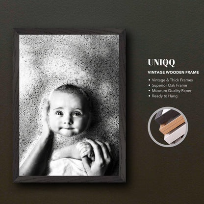 Vintage framed print of a serene baby surrounded by bubbles in black and white photography.
