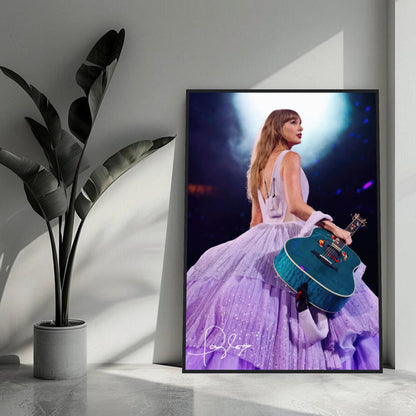 Taylor Swift framed poster in lavender gown holding a blue guitar, showcased in a stylish indoor setting.