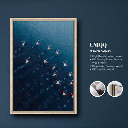 Framed canvas print of flamingos in flight over blue waters, showcasing drone photography with high-quality materials.