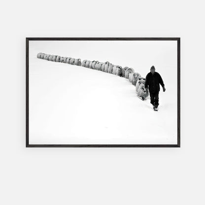 Black-and-white art of a shepherd guiding sheep through a snowy landscape, framed in vintage style.