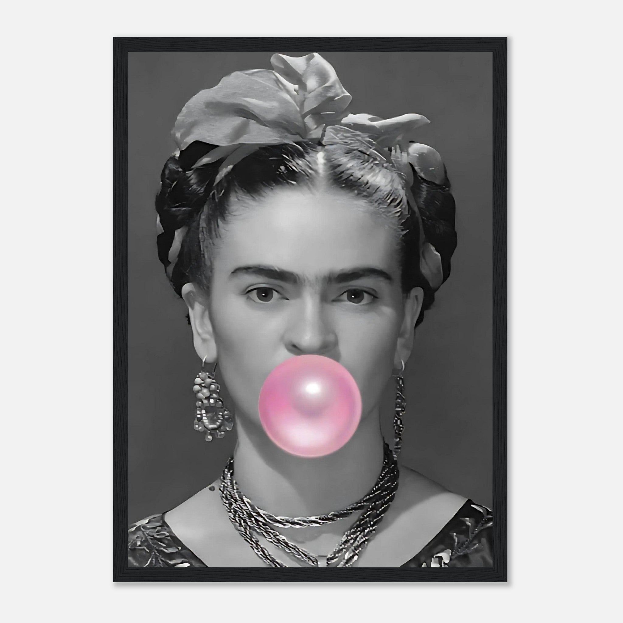 Frida Kahlo framed print featuring a black and white image of her blowing a pink bubble gum.