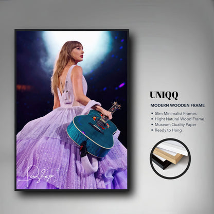 Taylor Swift Framed Poster showcasing her in a lavender gown with a guitar, perfect for fans and home decor.