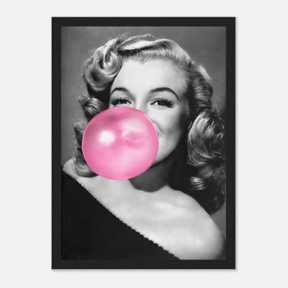 Framed print of Marilyn Monroe blowing pink bubble gum, radiating glamour and style in a cheeky, vintage look.