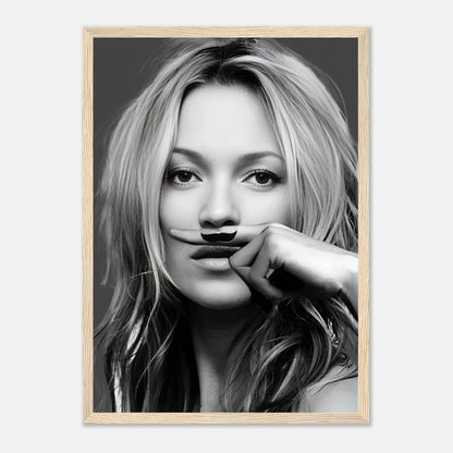 Black-and-white framed print of a woman playfully holding a mustache, showcasing elegance and humor in contemporary art.