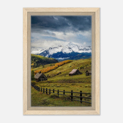 Framed canvas print of Telluride, Colorado featuring snow-capped mountains and rustic barns in a scenic valley.