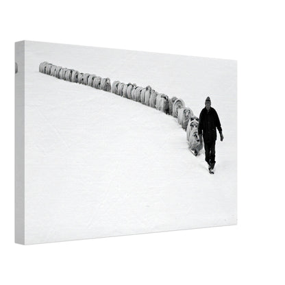 Black-and-white canvas print of a shepherd leading sheep through a serene snow-covered landscape.