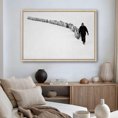 Framed canvas print of a shepherd guiding sheep through a snow-covered landscape, symbolizing rural life and tradition.
