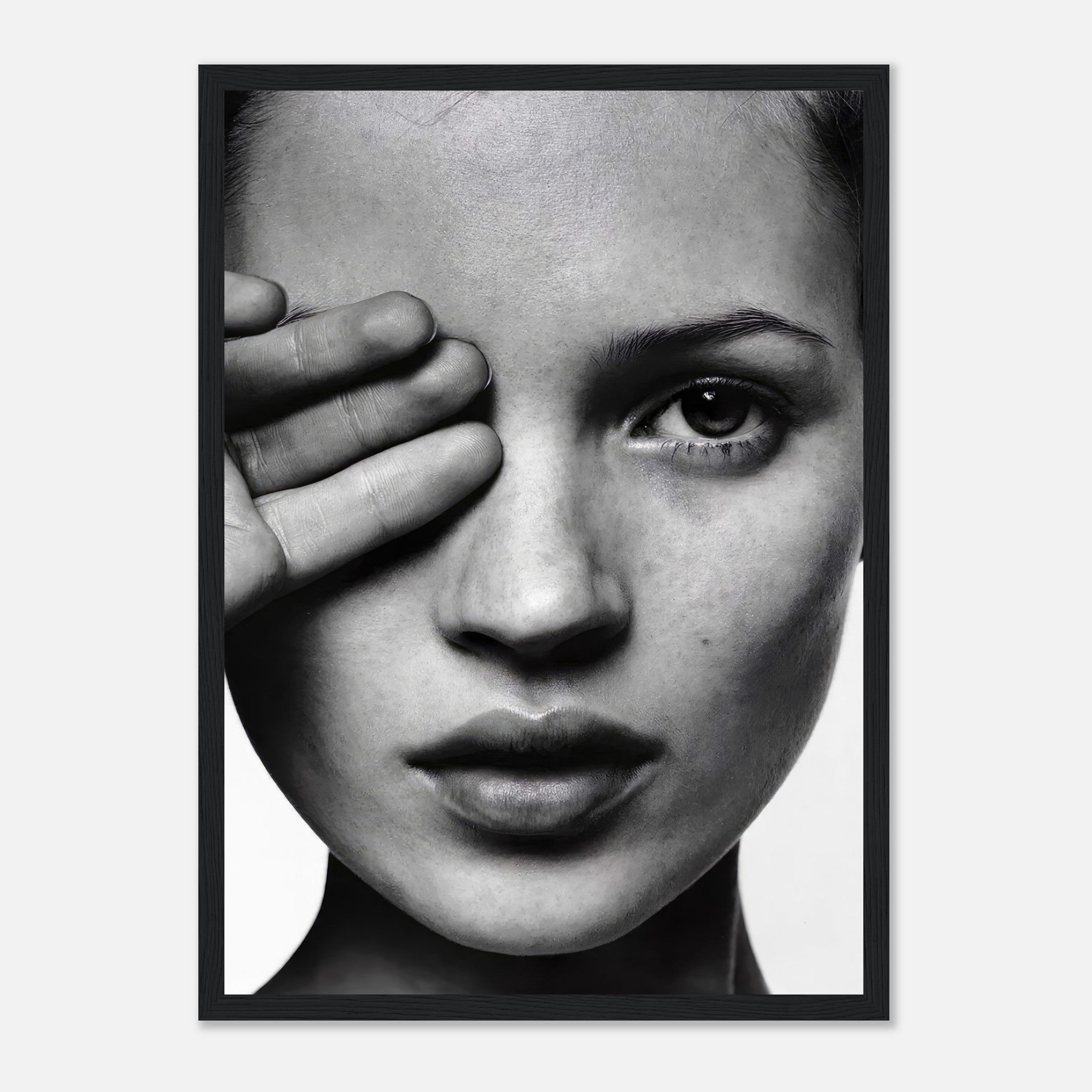 Kate Moss striking black and white photography framed print with one hand covering her eye, showcasing elegant portrait artistry.