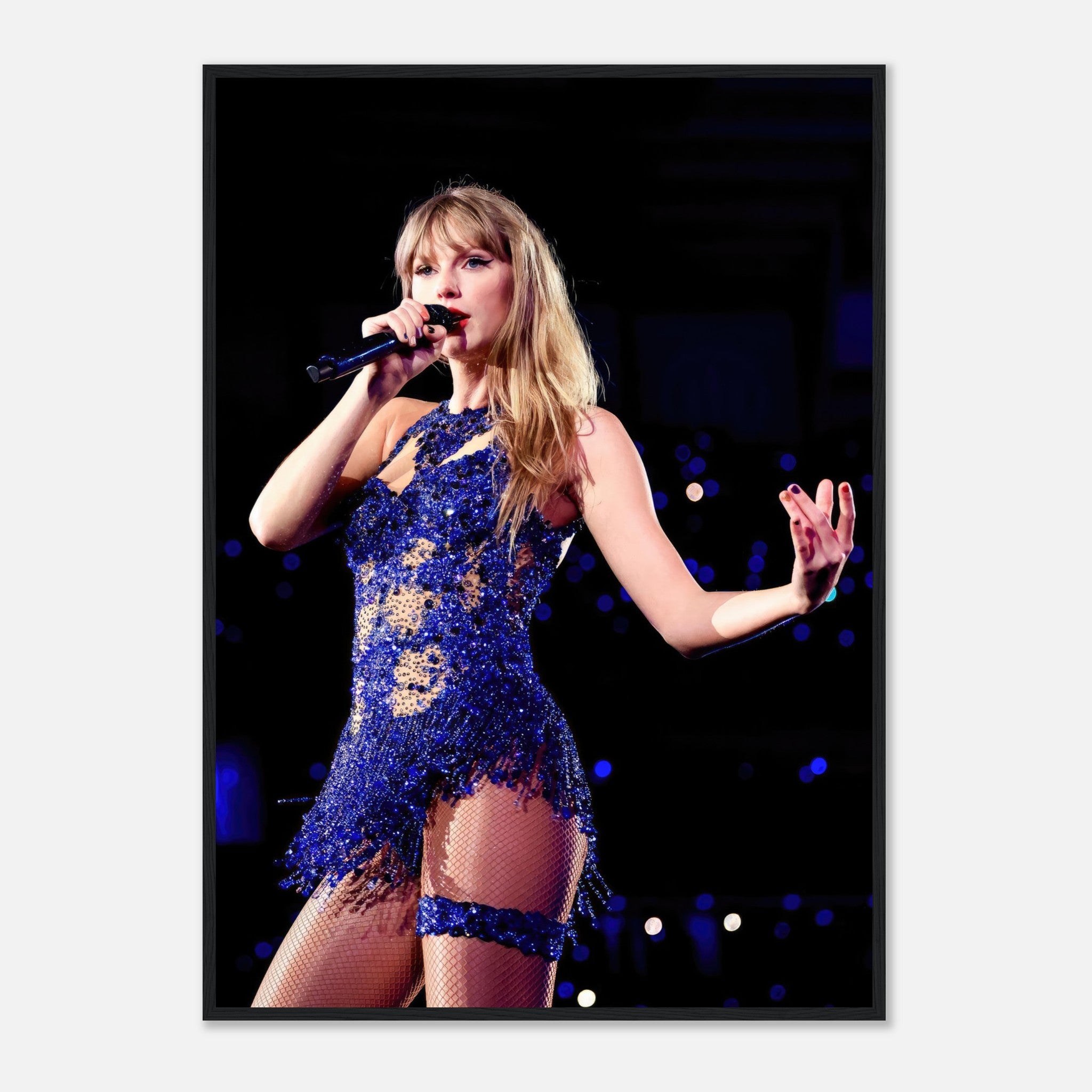 Taylor Swift performing in a dazzling blue outfit, capturing her dynamic stage presence in a framed print.