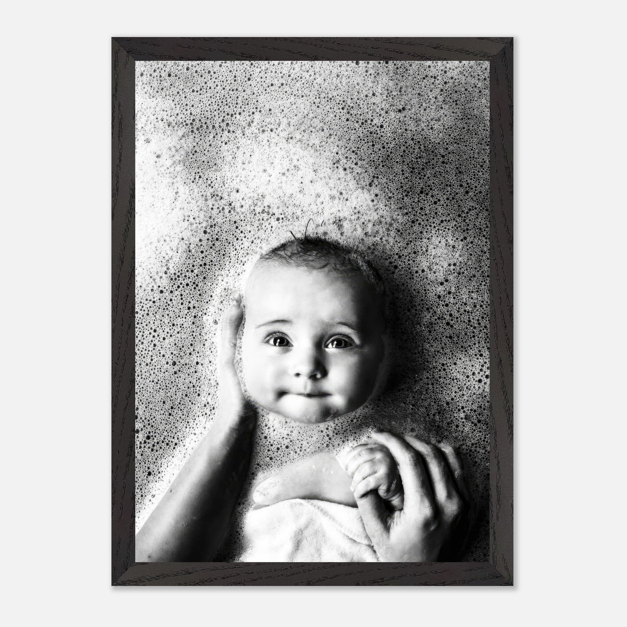 Black and white vintage print of a baby in a bubble bath, exuding innocence and nostalgia, framed elegantly.