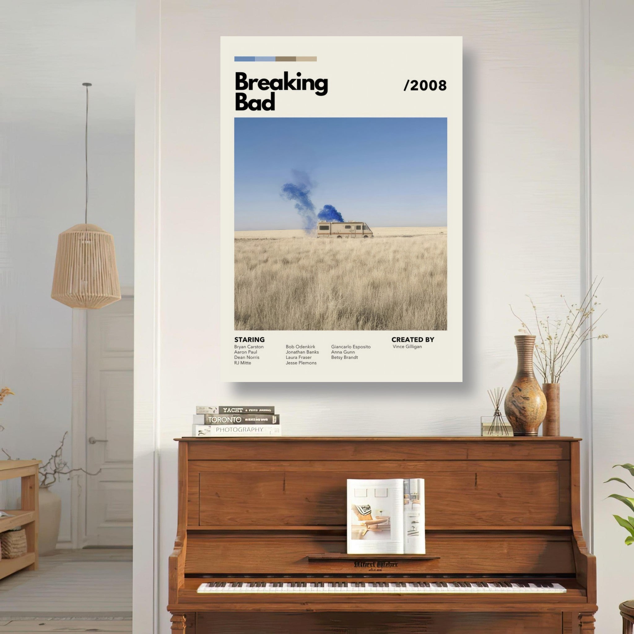 Vintage Breaking Bad metal poster featuring an RV and blue smoke in a desert landscape, displayed above a piano.