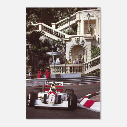 Ayrton Senna racing through Monaco in his iconic car, captured in a brushed metal print with a striking metallic finish.