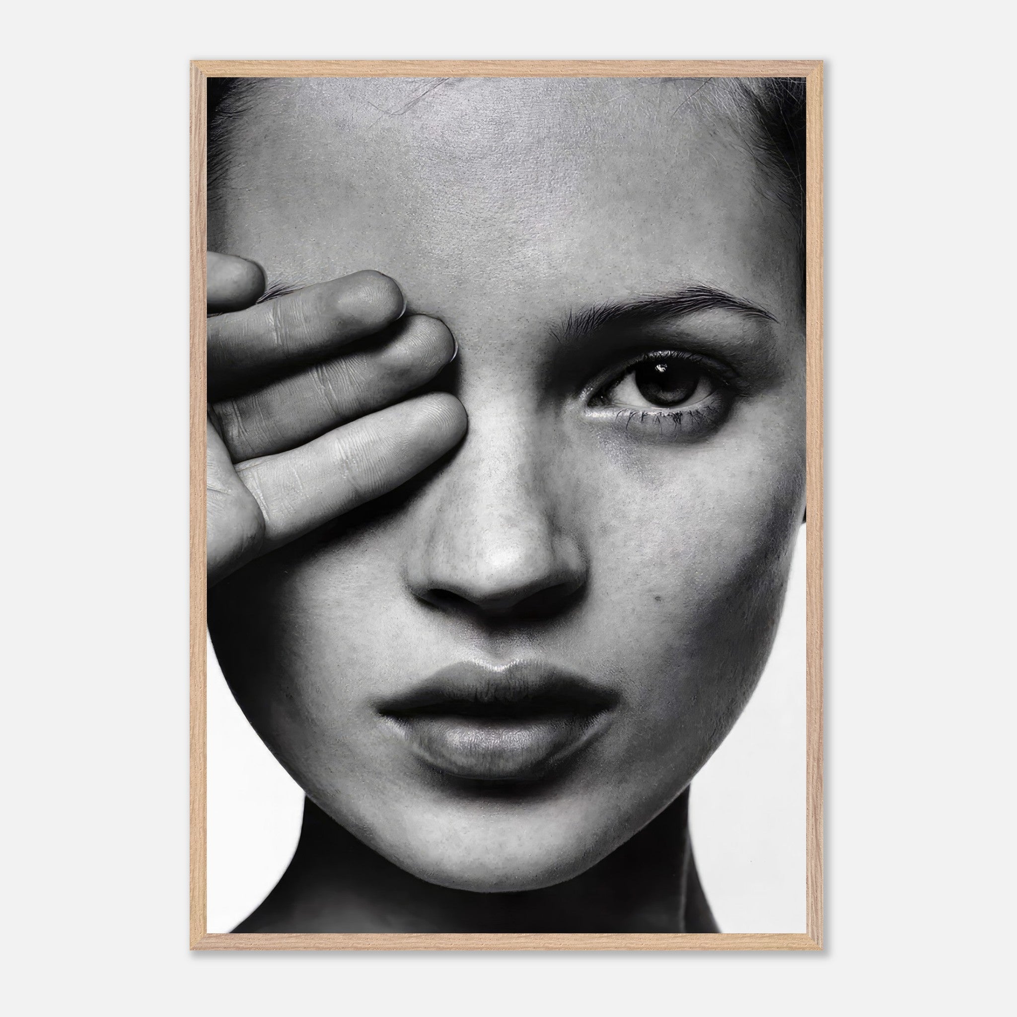 Kate Moss black and white photography framed print, showcasing an elegant close-up portrait with a striking monochromatic design.