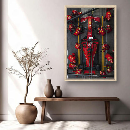 Framed canvas print of a Ferrari Formula 1 pitstop, showcasing vibrant colors and dynamic racing action for stylish décor.