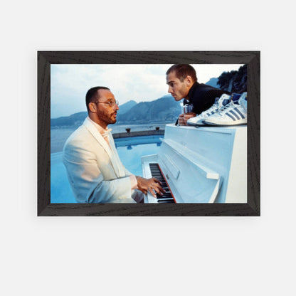 Jean Reno at the piano in a vintage framed print from "The Big Blue" with a scenic seaside background.