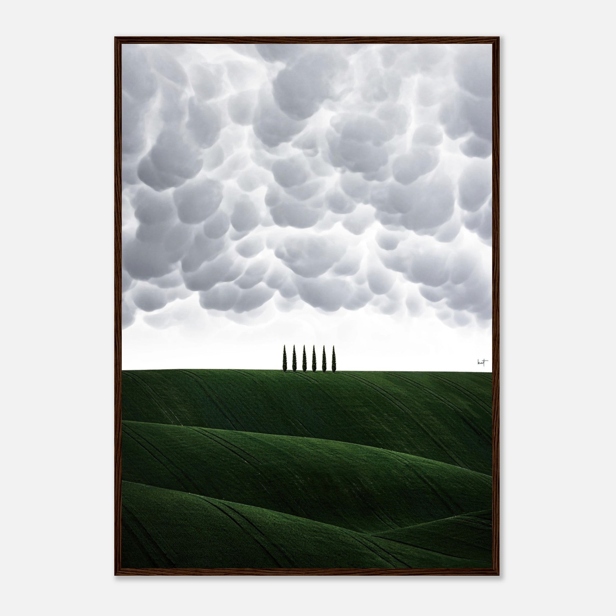 Framed print of Tuscany, Italy featuring rolling green hills and cypress trees under dramatic clouds.