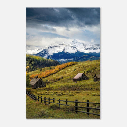 Telluride, Colorado metal print showcasing snow-capped mountains, rustic barns, and autumn foliage under a dramatic sky.