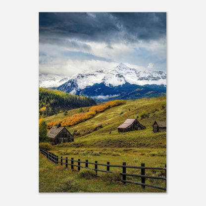 Telluride, Colorado poster showcasing rustic barns and vibrant autumn foliage against snow-capped Rocky Mountains.