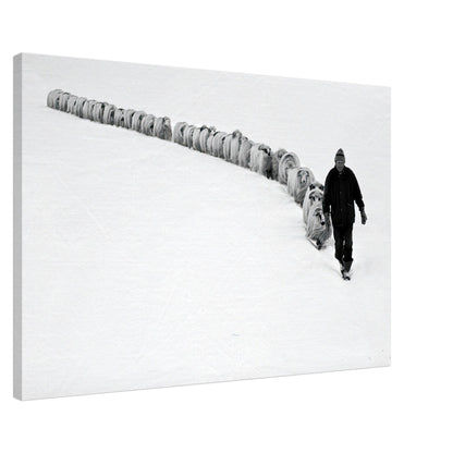 Black-and-white canvas print of a shepherd walking with his flock in a serene snow-covered landscape.