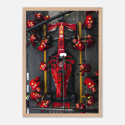 Framed fine art print of Ferrari Formula 1 pitstop, showcasing teamwork and precision of the pit crew in vibrant colors.