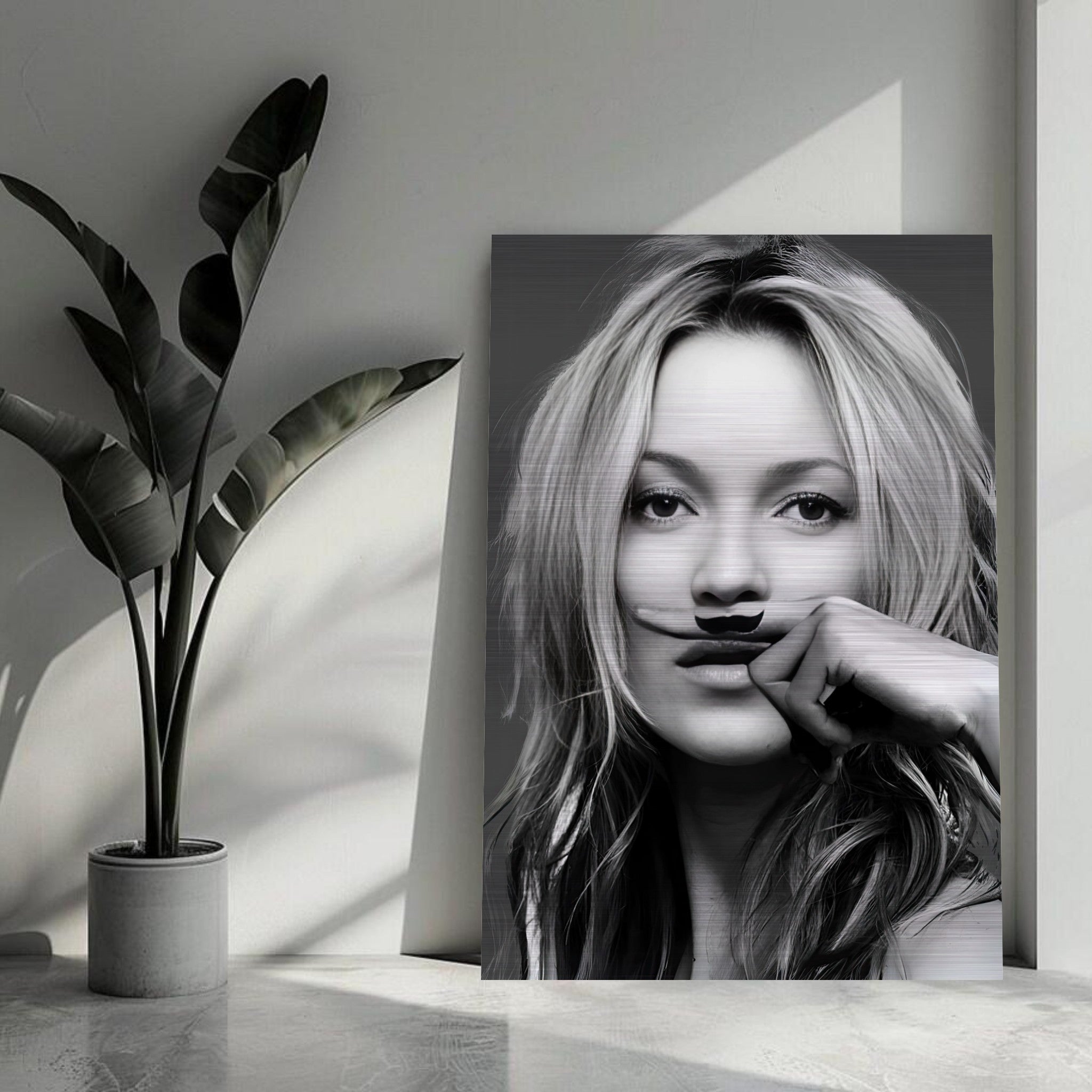 Kate Moss Mustache artwork in brushed metal, adding bold style and texture to modern decor.